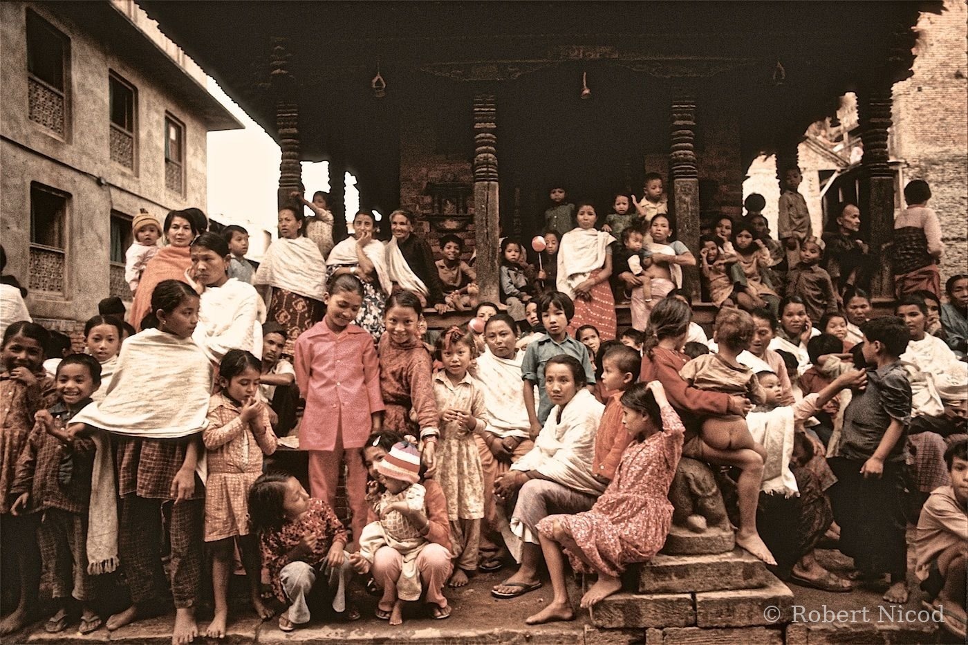 Nepal 1977 — Indra Jatra festival. Women and children gathered in front of a temple to watch the Kumari's chariot go by, Kathmandu 1977